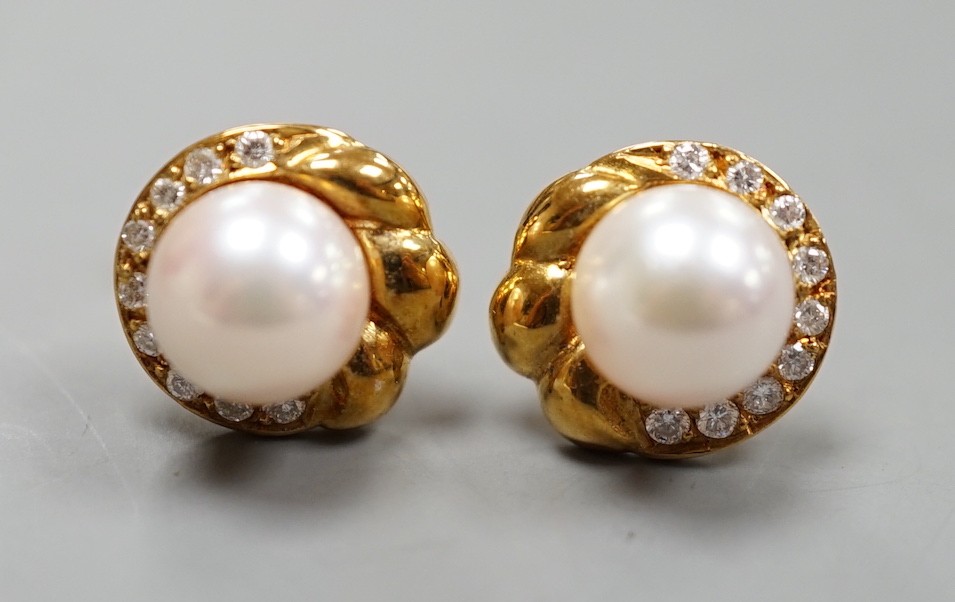 A modern pair of 18ct gold, cultured pearl and diamond chip set earrings, 12mm, gross weight 4.7 grams.